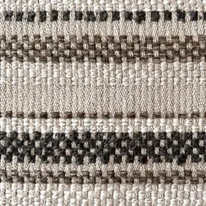 Close-up view of vintage jacquard fabric with geometric patterns for furniture upholstery.