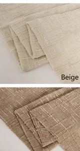Macro detail of textured chenille upholstery fabric showing beige and tan color variants