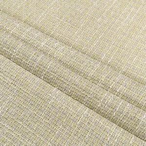 Macro detail of high-quality yellow bouclé tweed fabric with silver metallic thread