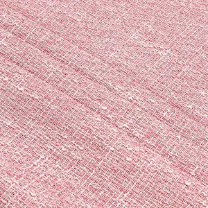 Close-up macro detail of pink tweed fabric with woven silver thread for autumn winter fashion