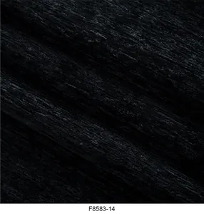 Primo piano macro di tessuto ciniglia nero strutturato per tappezzeria e decoro.