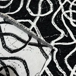 Vista macro dettagliata del tessuto jacquard in ciniglia astratta bianca e nera per divani