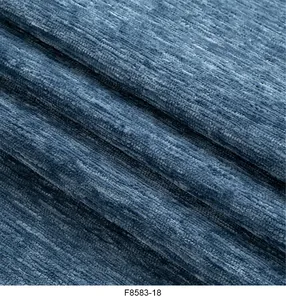 Primo piano di tessuto ciniglia blu che mostra trama tessuta densa e motivi a coste