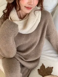 Close-up detail of soft cream knitted infinity snood scarf for winter neck warmth