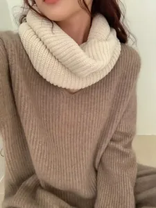 Detailed view of a soft white knitted infinity scarf snood with thick ribbed texture.
