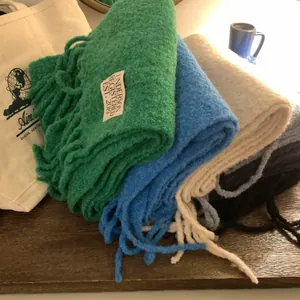 Thick wool scarves with long fringes in various colors by UNDERSON for winter warmth