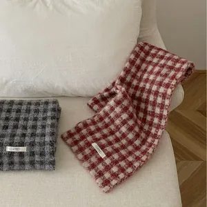Soft and cozy red and grey checkered knitted scarves for winter warmth and stylish comfort.