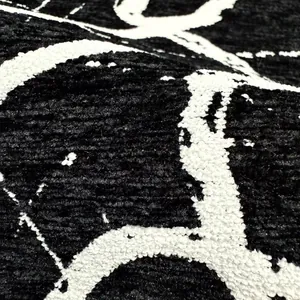 Primo piano di tessuto jacquard ciniglia bianco e nero con motivo a trama retrò moderno.