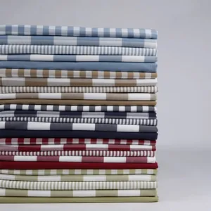 Stack of various imitation linen fabrics with checkered and striped patterns for DIY