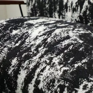 Macro view of black and white ink-wash style textured velvet fabric for modern sofa