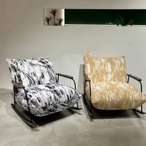 Two modern rocking chairs featuring ink wash and textured fabric upholstery in minimalist room