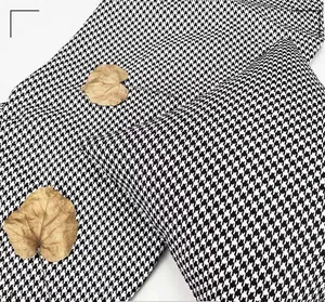Close-up of black and white houndstooth chenille fabric texture for home upholstery