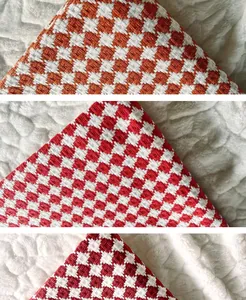 Close-up detail of cotton linen thickened grid fabric in orange and red woven tones