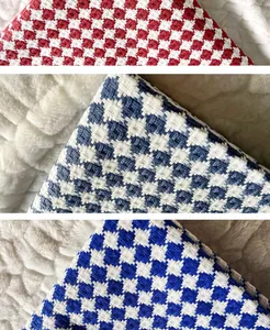 Close-up of thick checkered cotton linen fabric in red and blue shades for home decor.