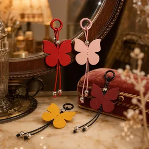 Detailed view of colorful butterfly leather charms on a vintage dressing table