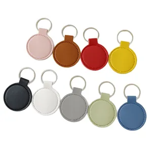 Multi-color circular PU leather keychains with metal rings on white background.