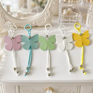 Macaron colored leather butterfly keychains set for stylish bag charms and gifts.