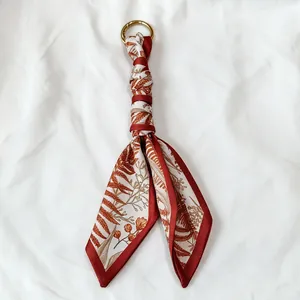 Floral print silk scarf keychain with gold ring, forest style bag accessory.
