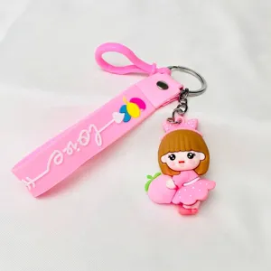 Detailed view of cute soft rubber girl keychain with peach and Love wrist strap