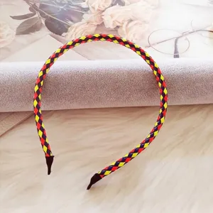 Detailed close-up view of a vibrant woven PU leather headband with red and yellow patterns