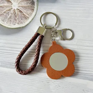 Portachiavi alla moda in pelle intrecciata con fiore arancione e mini specchio portatile