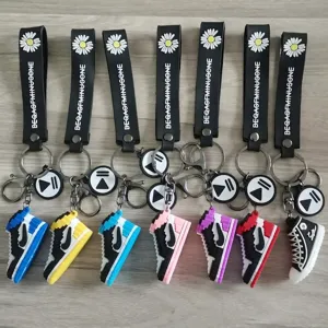 Detailed view of colorful sneaker keychains with decorative straps and daisy logos