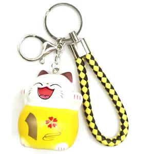 Lucky cat keychain with black and yellow braided leather strap and silver ring