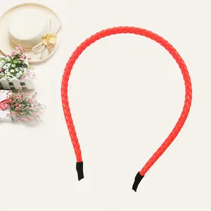 Close-up of bright red PU leather braided headband with smooth glossy finish