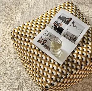 Detailed texture of vintage shell pattern jacquard floor cushion on textured rug