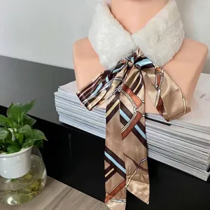 Detailed shot of a long silk scarf with equestrian print tied in a bow on a collar