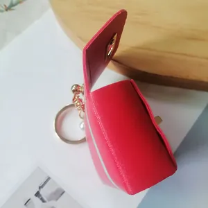 Vintage red leather mini pouch keychain featuring a gold ring and elegant pearl charm