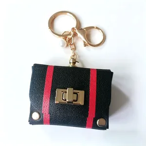 Stylish vintage leather mini bag keychain with red stripes and polished gold hardware