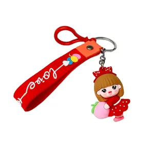 Cute cartoon girl soft rubber keychain featuring a doll holding a peach with red love strap