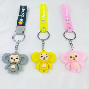Set of three colorful Cheburashka character keychains in gray, yellow, and pink PVC