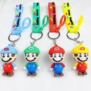 Macro view showing four colorful pixel art Mario character keychains with matching straps
