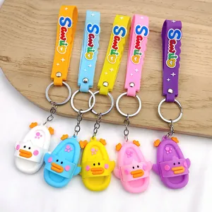 Close-up detail of five colorful cartoon duck slipper keychains with PVC straps