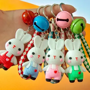 Close-up detail of cute 3D knit-texture rabbit keychains with colorful bells and straps