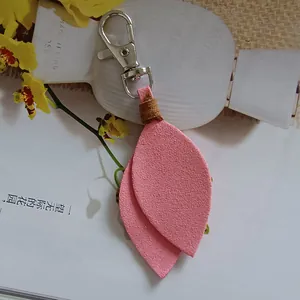 Close-up detail of soft pink suede leaf keychain with a durable silver lobster clasp