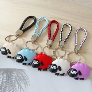 Vijf kleurrijke Shaun het Schaap siliconen sleutelhangers met gevlochten leren riemen.