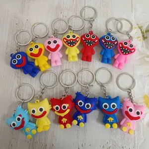 Group of colorful Poppy Playtime characters keychains on a white wooden background