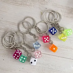 Close-up of colorful resin dice keychains featuring a variety of vibrant transparent colors