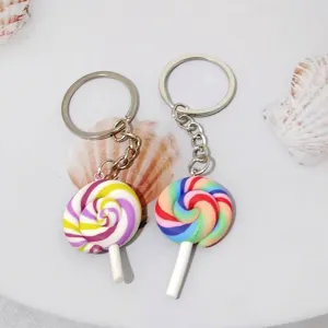 Detailed macro view of two colorful lollipop keychains with vibrant rainbow swirl patterns