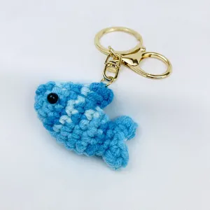 Hand-crocheted blue fish keychain with gold-plated metal clasp for backpacks and bags
