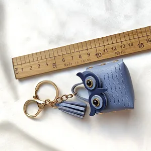 Vue détaillée du porte-clés hibou en cuir bleu avec pompon et règle de mesure