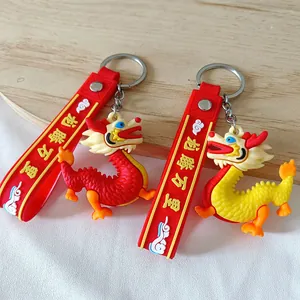 Adorable PVC dragon keychains with red wrist straps featuring Chinese soaring dragon text