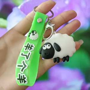 Detail view of a cute cartoon sheep keychain with an embossed green silicone strap