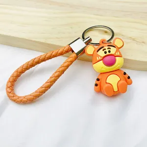 Detailed close-up of a cute Tigger cartoon keychain featuring an orange braided strap