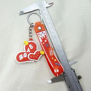 Close-up of cute silicone heart keychain being measured with a vernier caliper