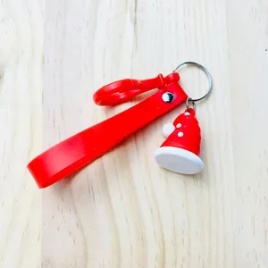 Detailed view of red Christmas Santa hat keychain with durable silicone wrist strap