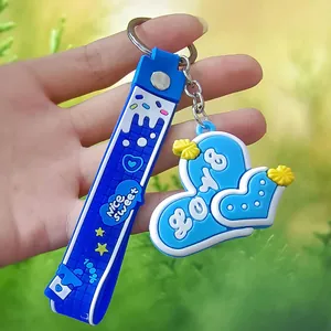 Close-up detail of a 3D blue silicone heart keychain with nice sweet printed strap
